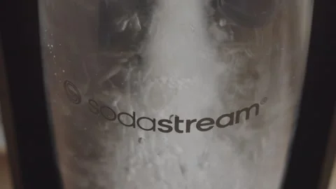 Sodastream logo on bottle with bubbles when operating close up Stock Footage 290090123