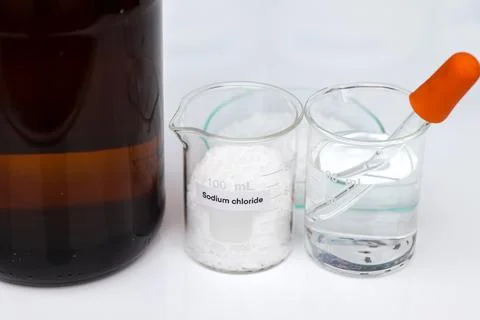 Sodium chloride in glass, chemical in the laboratory and industry Stock Photos
