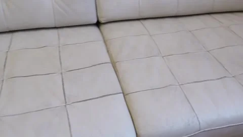 Sofa cleaning process showing dirt removal from a white couch Stock Footage 328350065