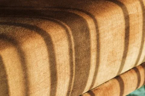 Sofa cushion with sunlight pattern on it, abstract cozy interior Stock Photos