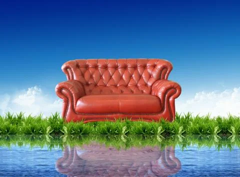 Sofa on the grass with the bright sky Stock Photos