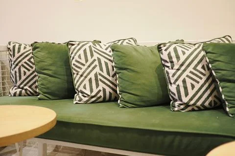 Sofa with green cushions and patterned pillows Stock Photos