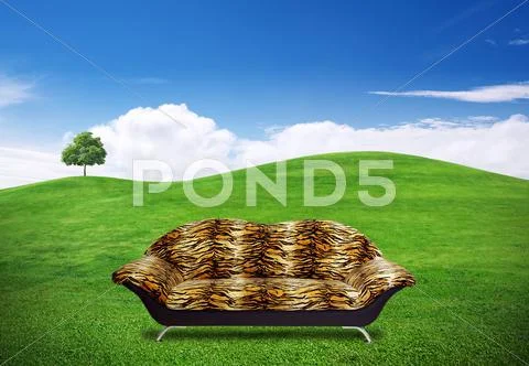 Sofa in green grass field Stock Illustration