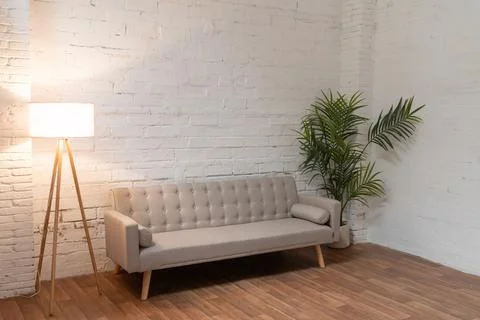 Sofa over white brick wall with copy space Stock Photos