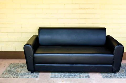 Sofa with yellow wall Stock Photos