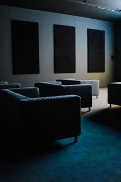 Sofas Pointing to a Screen in a Treated Entairtainment Room Stock Photos