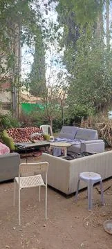 Sofas, table and chairs outside in the courtyard of the house in summer, fu.. Stock Photos