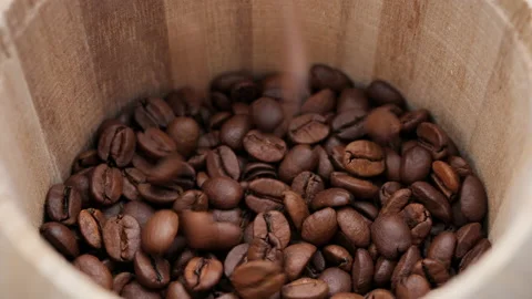 Сoffee beans fall into the wooden jar, close up Stock-Footage 220545377