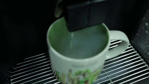Сoffee machine pours coffee latte into a сup. Close up. Stock Footage 83585719