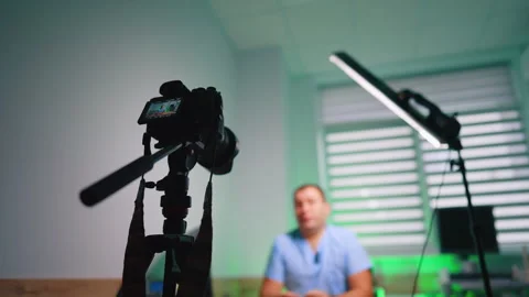Soffit and camera on tripod directed on the unrecognized man. Low angle view. Stock Footage 334339252