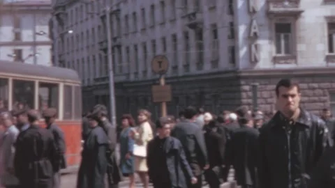 Sofia - 1967: Crowded street with people and a red bus outside Hotel Balkan Stock-Footage 168601107