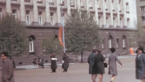 Sofia - 1967: View of the Largo buildings in Bulgaria – Pedestrians on the road 스톡 동영상 168601060