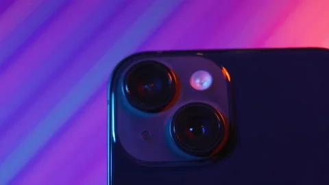 Sofia, Bulgaria-06 11 2022: Close up iPhone 14 spinning against abstract neon Stock-Footage 222052484
