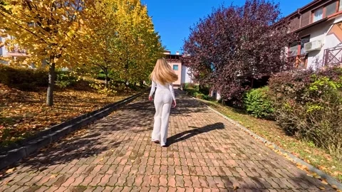 Sofia, Bulgaria - 10.19.2025. Young slender woman with long blond hair walks Stock Footage 319964235