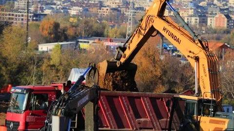 Sofia, Bulgaria - 11.13.2025. A construction site, a yellow excavator digs with Stock Footage 321355006