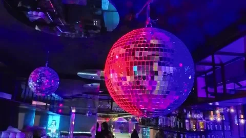 Sofia, Bulgaria - 12.31.2025. Shining bright disco ball in neon pink lighting in Stock Footage 326167148