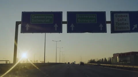Sofia, Bulgaria - 15 Mar, 2023: Direction signs on highway drive at sunset, s Video stock 325626610