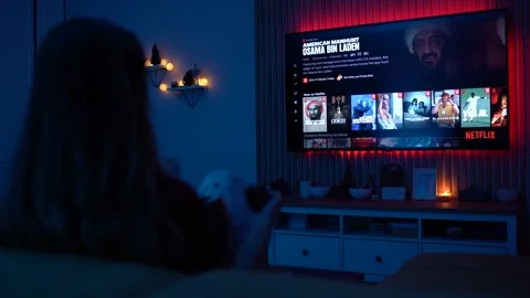 Sofia, Bulgaria-17 05 2025 : Woman Streaming Netflix on TV at Night While Stock Footage 310361610