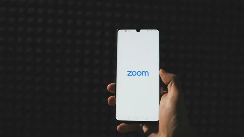 Sofia, Bulgaria-22 05 2020: Close up of Zoom app starting on smartphone . Zoom Stock Footage 131251642