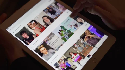 Sofia, Bulgaria-23 03 2020: Hand scrolling through TikTok video catalogue Video stock 127184539