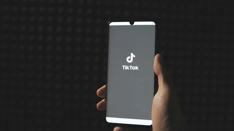 Sofia, Bulgaria-25 05 2020: Hands Turning tablet and scrolling TikTok app videos Stock Footage 131253913