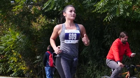 Sofia Bulgaria annual marathon - young sports girl running in slow motion Stock Footage 68385090