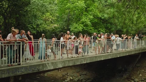 SOFIA, BULGARIA - AUGUST 29, 2026: Large crowd leaning on bridge railing over Stock-Footage 345900707