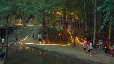 SOFIA, BULGARIA - AUGUST 29, 2026: Illuminated pathways along forest stream 動画素材 345900860