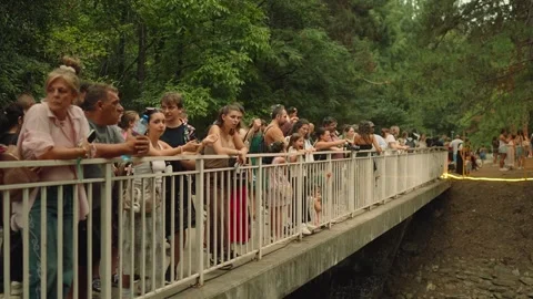 SOFIA, BULGARIA - AUGUST 29, 2026: Crowd of people leaning on bridge railing 動画素材 345900921