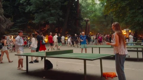 SOFIA, BULGARIA - AUGUST 29, 2026: Young couple playing table tennis at outdoor Stock-Footage 345900946