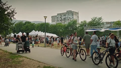 SOFIA, BULGARIA - AUGUST 29, 2026: People strolling near white market tents and 動画素材 345901022