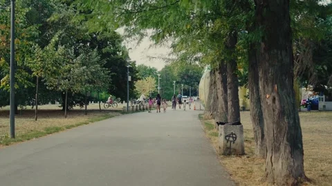 SOFIA, BULGARIA - AUGUST 29, 2026: People strolling along paved park alley 動画素材 345901197