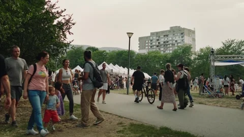 SOFIA, BULGARIA - AUGUST 29, 2026: People walking near market tents and Stock-Footage 345901239