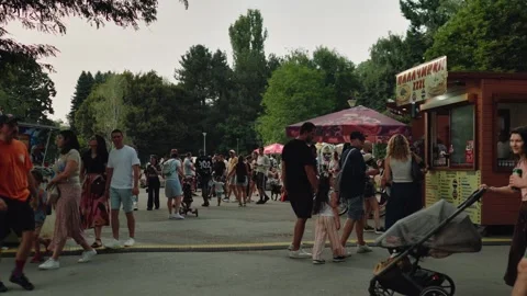 SOFIA, BULGARIA - AUGUST 29, 2026: Crowds of people strolling past pancake food Stock-Footage 345901629