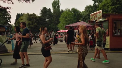 SOFIA, BULGARIA - AUGUST 29, 2026: People walking past street food stall 動画素材 345901675