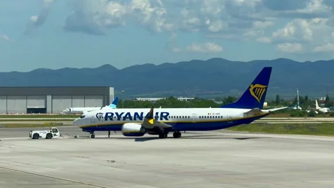 Sofia, Bulgaria - June 08, 2026: Ryanair airplane is being towed by a ground Stock Footage 341692210
