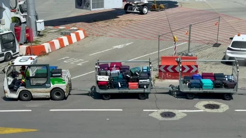 Sofia, Bulgaria - June 08, 2026: Luggage transport vehicles pull multiple carts Stock Footage 341692218