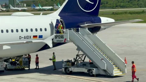 Sofia, Bulgaria - June 08, 2026: Ground crew members in reflective vests assist Stock-Footage 341692270
