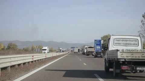 Sofia, Bulgaria - Mar 12, 2025: Highway traffic with cars and trucks on a cle Stock Footage 310334276