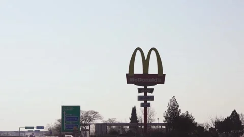 Sofia, Bulgaria - Mar 12, 2025:  Highway roadside signs and prominent McDonal Stock Footage 320972331