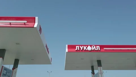 Sofia, Bulgaria - Mar 12, 2025: Red and white Lukoil gas station with clear b Video stock 320972376