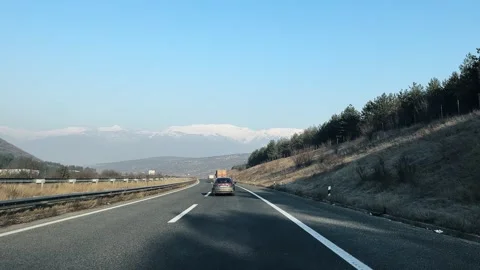 Sofia, Bulgaria - Noe 14, 2024: Vehicles drive on highway with amazing mountain Stock Footage 250114552