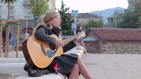 SOFIA, BULGARIA - SEPTEMBER 2016: Street musician women with guitar songs Stock Footage 72829525