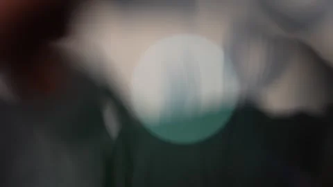 Soft abstract photo with large mint-green bokeh circle floating over dark Stock Footage 330188425