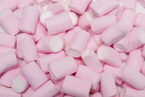 Soft and fluffy pink marshmallows arranged in random pattern on clean white.. Stock Photos