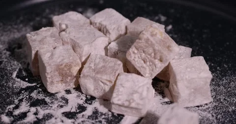 Soft and fresh Turkish delight sprinkled with powdered sugar, cubic sweet white Stock Footage 327050444