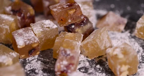 Soft and fresh Turkish delight sprinkled with a small amount of powdered white Stock Footage 327632631