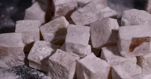 Soft and fresh Turkish delight sprinkled with powdered white sugar, cubic sweet Stock Footage 328230685