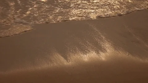 Soft and gentle sea waves over sandy beach at golden sunset hours in 4K 스톡 동영상 75896716