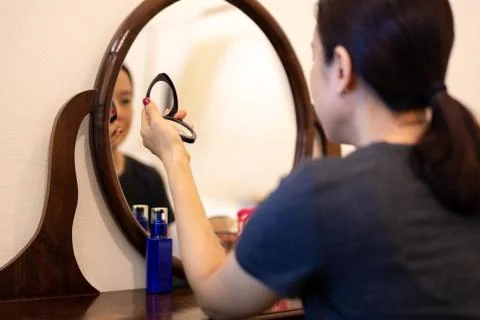 Soft and selective focus woman's hand holding compact powder doing makeup. Stock Photos